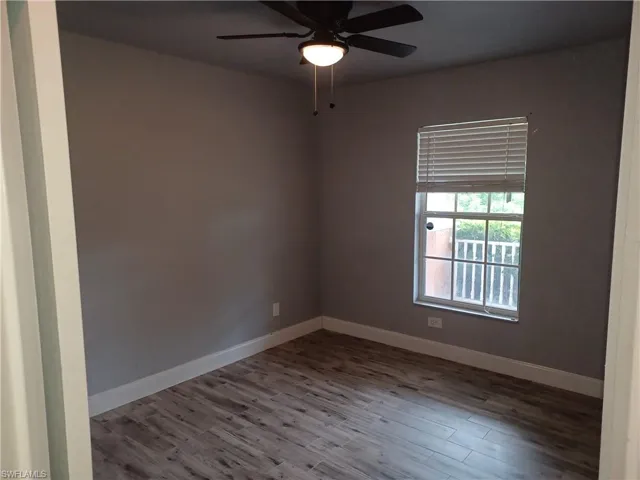 Unfurnished room featuring wood finished floors and ceiling fan