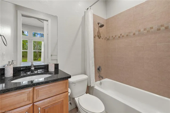 Full bathroom with vanity, toilet, and shower / tub combo