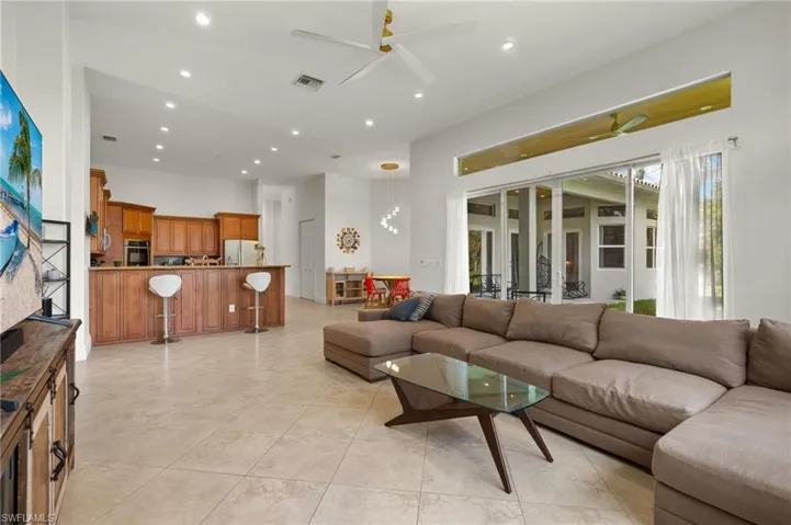 Tiled living room featuring ceiling fan