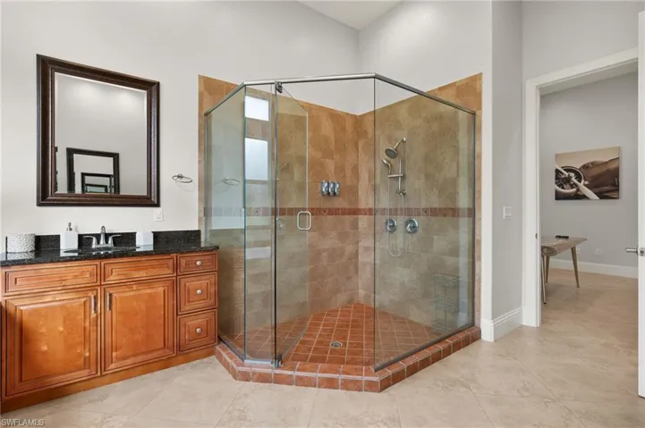 Bathroom featuring vanity and a shower with shower door