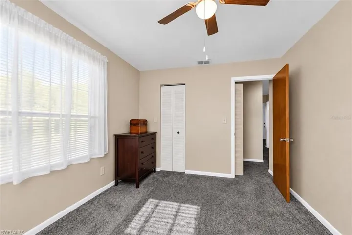 Neutral-toned walls complement the gray carpeting, creating a versatile interior