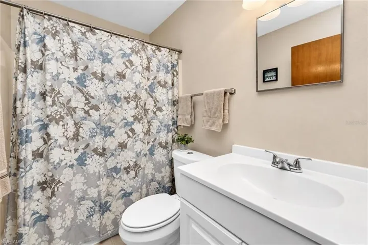 White vanity with integrated sink and chrome faucet