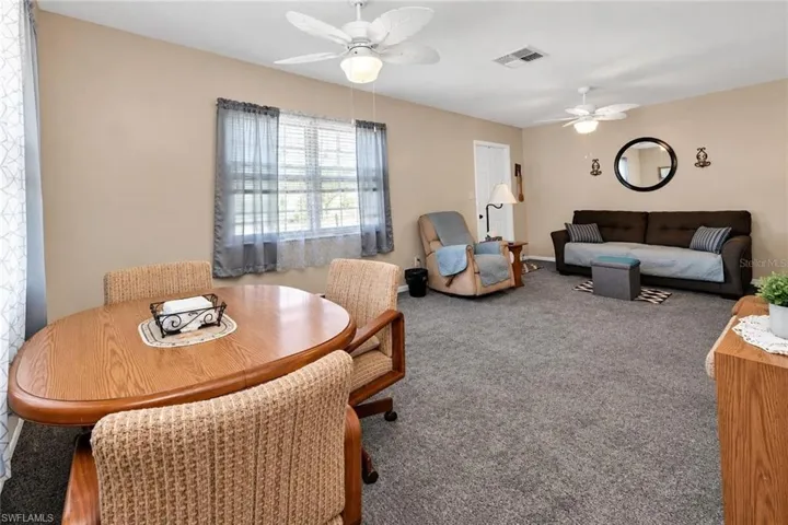 Neutral wall colors, recessed lighting, and two ceiling fans