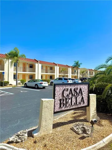 Community sign featuring uncovered parking