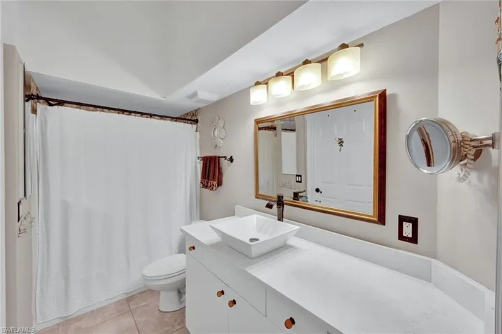 Updated guest bathroom with modern fixtures and a spacious vanity.