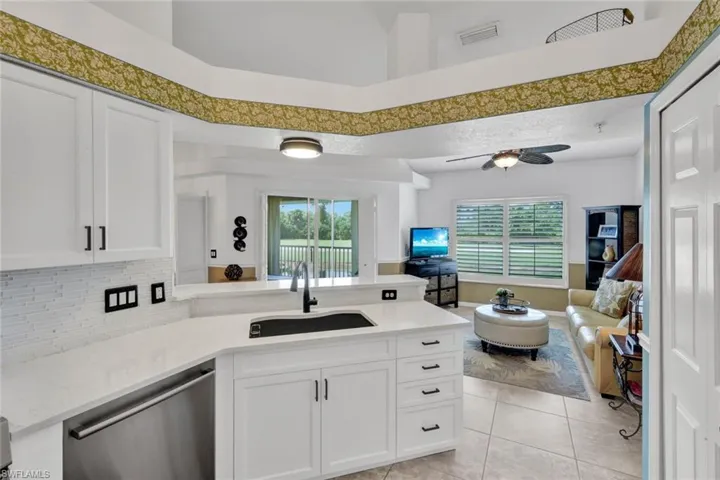 Beautifully updated kitchen with quartz counters and a bright, open view into the living area.