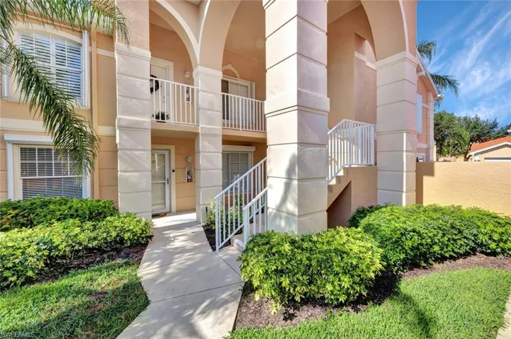 Charming walkway leading to the residence, surrounded by well-kept tropical landscaping.