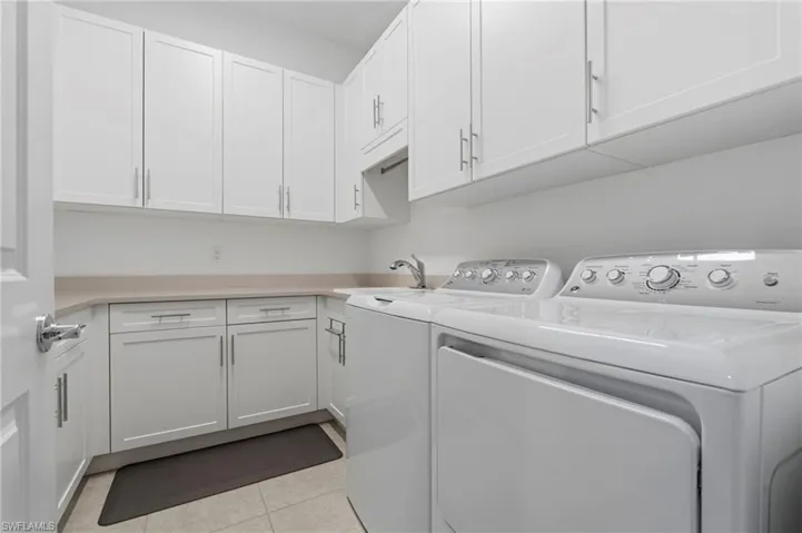 Spacious Laundry room with built-in cabinets and laundry sink.