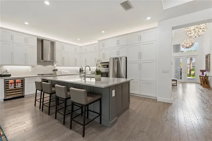 Experience luxury from the moment you step into the grand foyer to the massive great room, kitchen, and dining area, all boasting luxurious hardwood flooring throughout.
