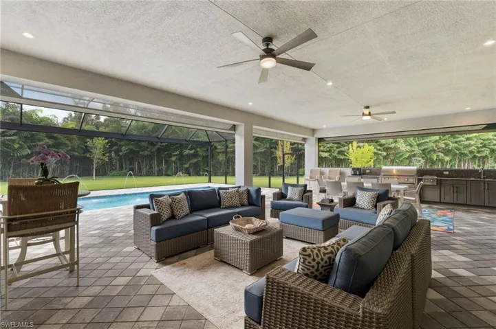 Experience optimal outdoor living with a 37' x 22' covered lanai area, with premium built-in outdoor kitchen, and feature wall, all protected from rain or storms with electric storm screens.