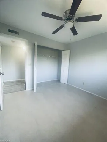 Unfurnished bedroom featuring a ceiling fan and a closet