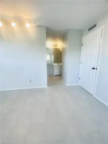 Unfurnished bedroom with baseboards and ensuite bath