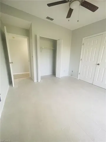 Unfurnished bedroom with a closet and ceiling fan
