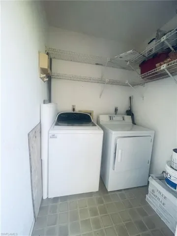 Laundry area featuring washing machine and dryer and water heater