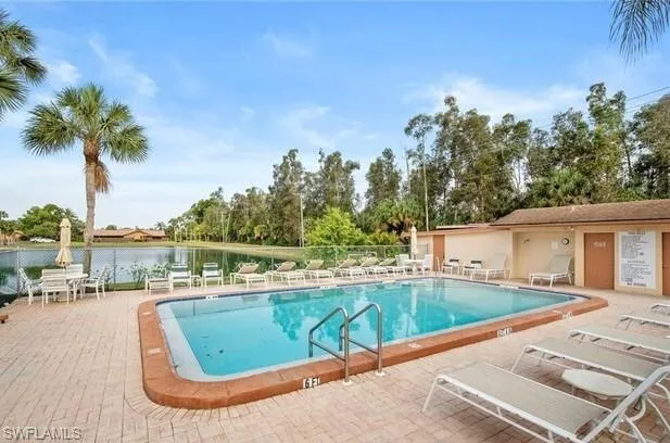 Community pool with a patio and a water view