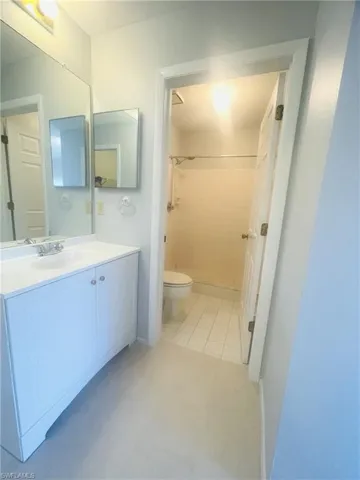 Bathroom featuring vanity, a shower, and light tile patterned floors