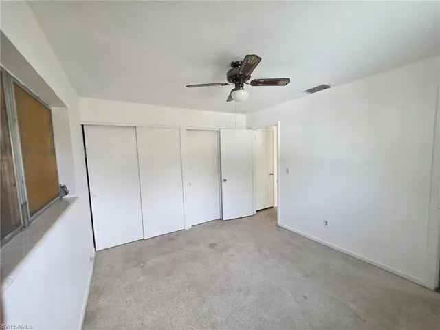 Carpeted interior space with white walls