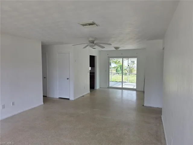 Spacious interior with neutral wall finishes and light-toned carpeting