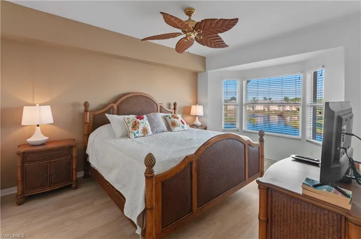 Bedroom with light hardwood / wood-style flooring and ceiling fan