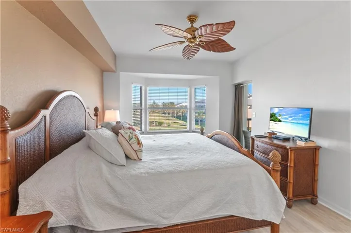 Bedroom featuring ceiling fan and light hardwood / wood-style flooring