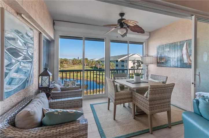 Sunroom / solarium featuring ceiling fan