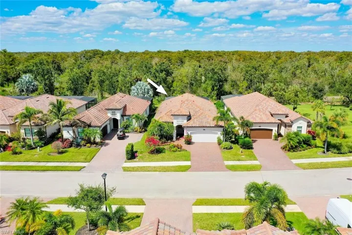 Twin Eagles single family home with lush landscaping and preserve view