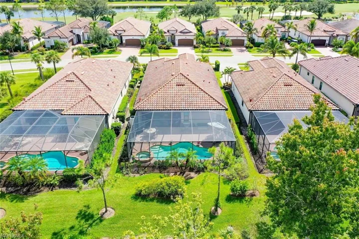 Single family Twin Eagles home with screened lanai featuring a swimming pool and spa