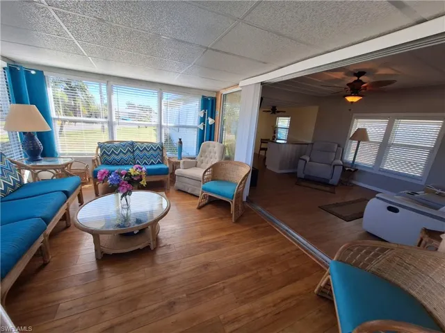 Living room featuring hardwood / wood-style floors and a drop ceiling