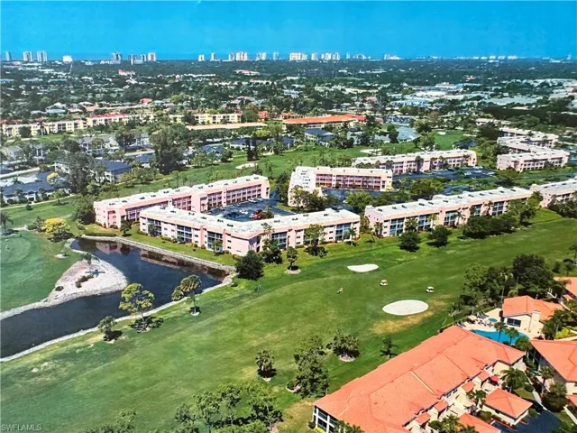 View of urban area featuring a local golf course and a large body of water