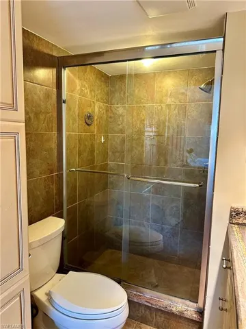 Full bath with vanity and a shower stall