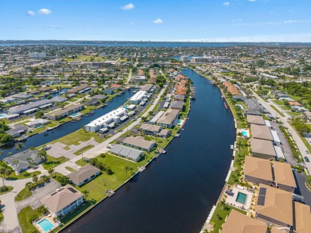 Aerial overview of property's location with a nearby body of water and nearby suburban area