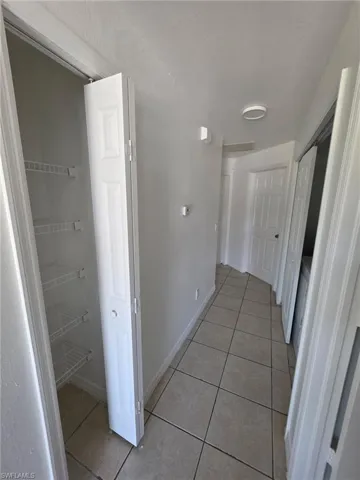 Corridor featuring light tile patterned floors