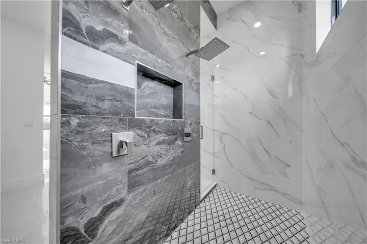 Bathroom with a marble finish shower