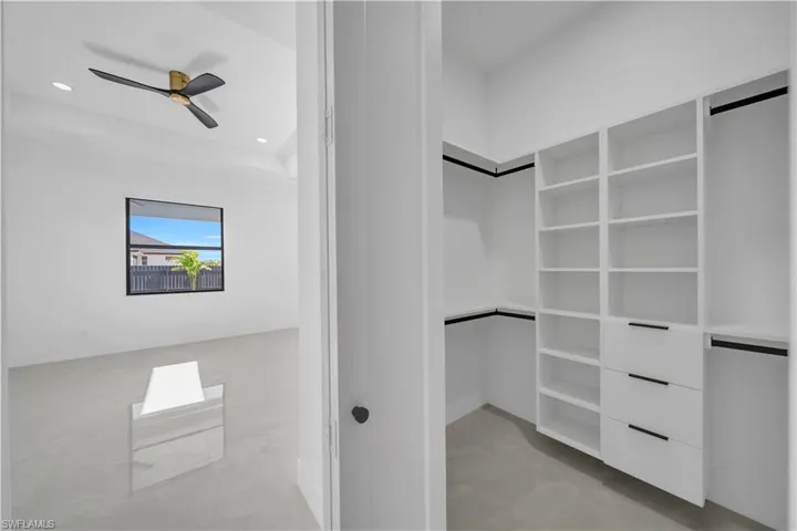 Spacious closet with a ceiling fan