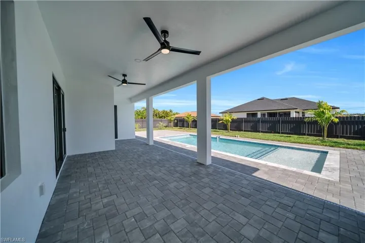 View of pool with a fenced backyard, a patio area, and ceiling fan