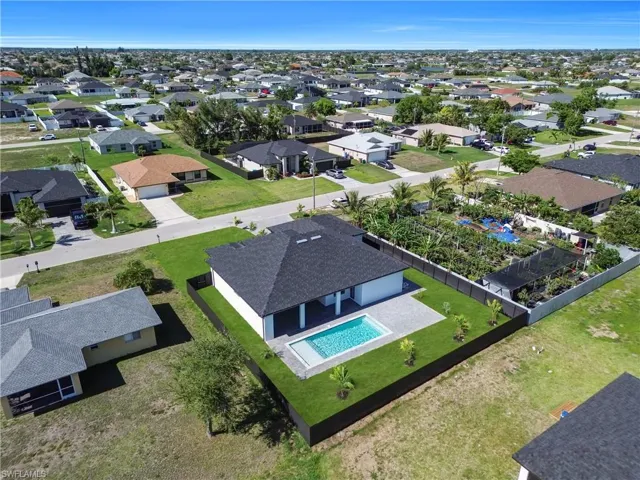Aerial perspective of suburban area featuring a pool area