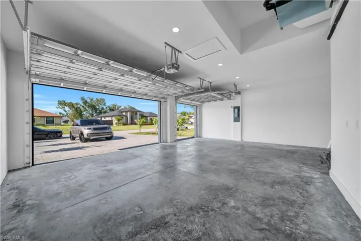 Garage with a garage door opener and recessed lighting