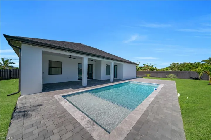 View of pool featuring a ceiling fan and a patio
