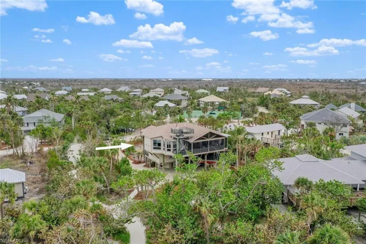 Exterior view of property with rooftop sundeck and beach path