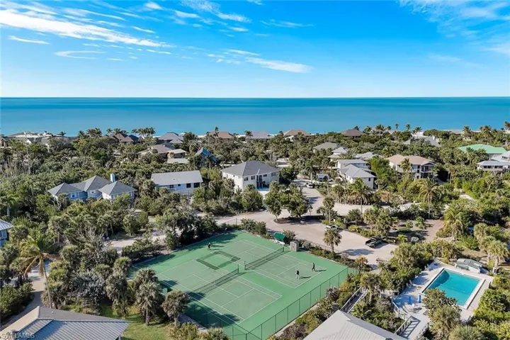 Aerial view of tennis, pool and beach