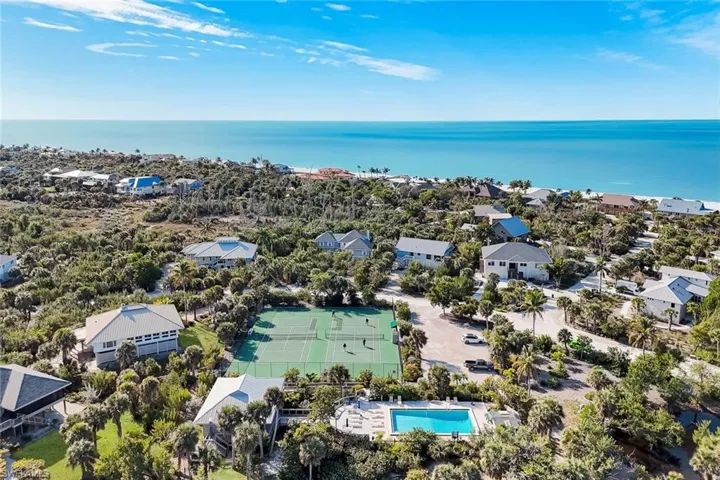 Aerial view of residential area featuring a nearby body of water