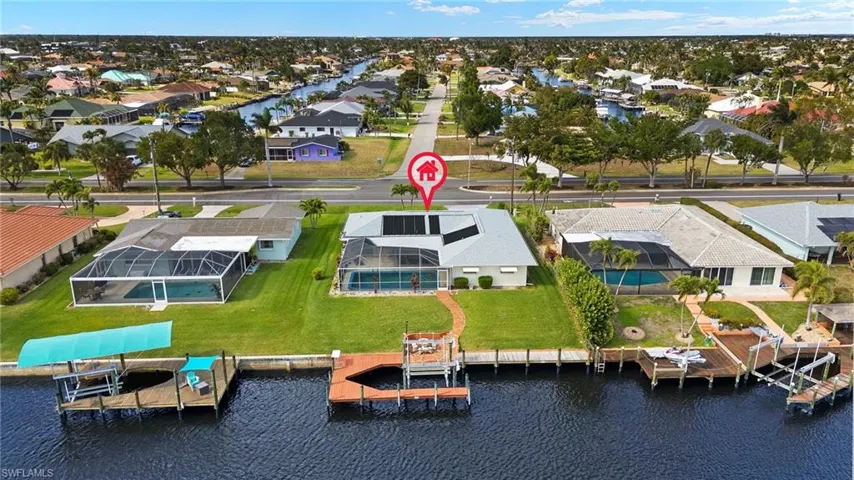 Aerial view of residential area featuring a nearby body of water