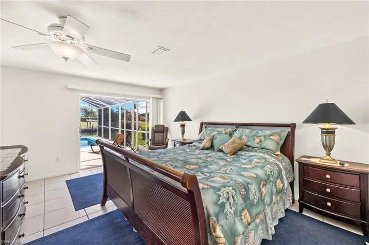 Bedroom featuring tile patterned floors, ceiling fan, access to outside, and a sunroom
