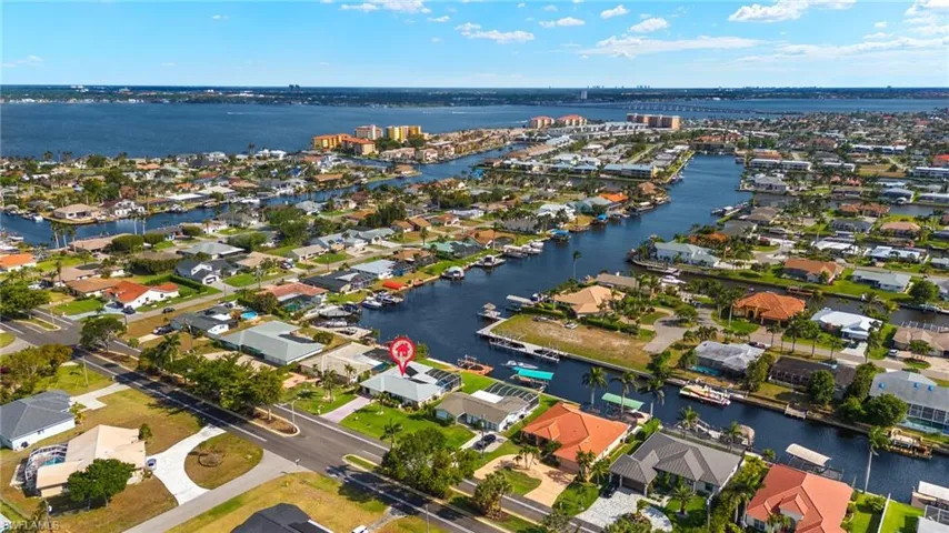 Aerial overview of property's location with a nearby body of water and nearby suburban area
