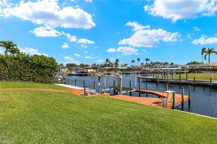 Dock with a yard, boat lift, and a water view