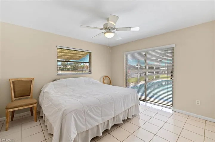 Bedroom with light tile patterned flooring and ceiling fan
