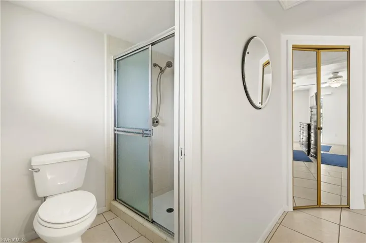 Full bath featuring light tile patterned floors and a stall shower