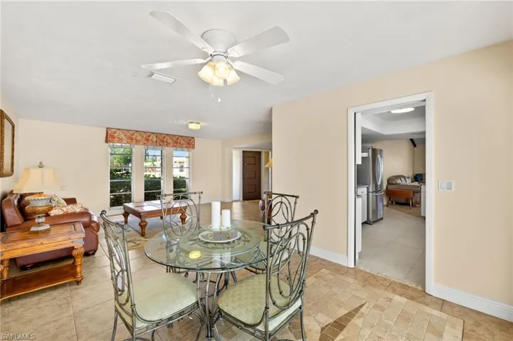 Dining area with ceiling fan and light tile patterned floors