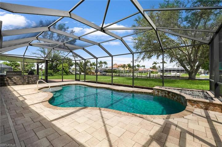 Enclosed pool with adjoining outdoor kitchen