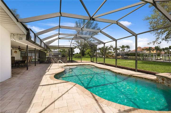 Screened in pool, bathroom off side sitting area, sunning area, outdoor kitchen